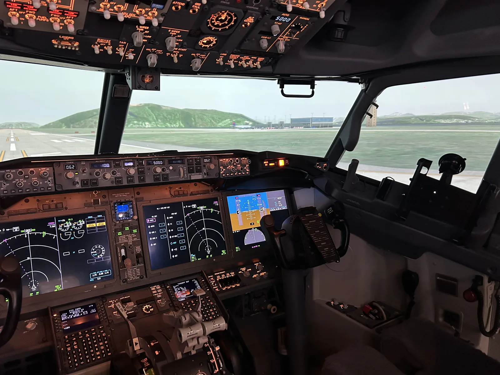Boeing 737 MAX simulator flight deck with visual scene